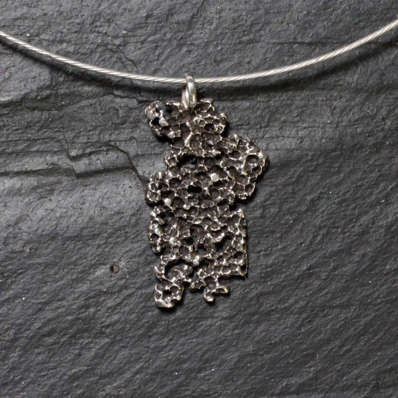 Colgante irregular en plata de ley de color óxido negro con cordón acero